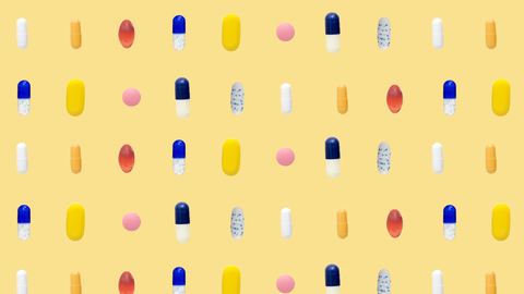 a bunch of different coloredshaped pills in rows on yellow background