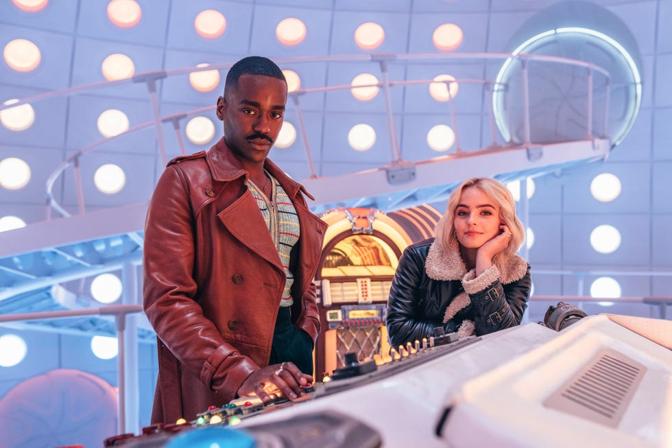 doctor who stars ncuti gatwa and millie gibson in the tardis, with the doctor's diner style jukebox in the background behind them