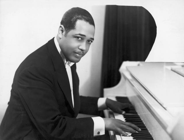 duke ellington seated at the piano