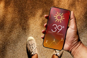 ecology and technology concept high temperature weather show on mobile screen on hot sunny day top view, grunge dirty concrete floor with sunlight as background