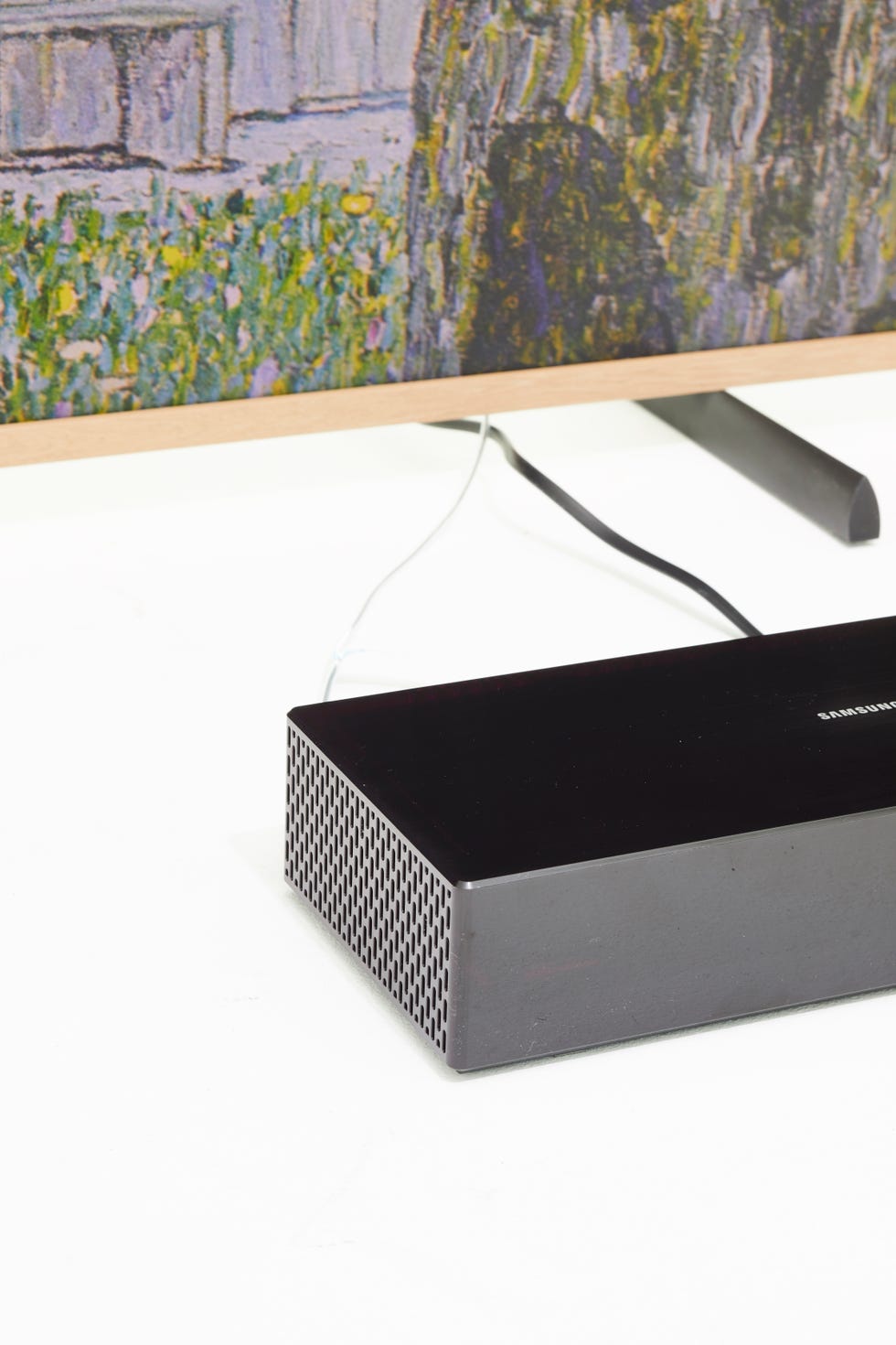 the one connect box is connected to the screen by a single, unobtrusive wire, so you can put it somewhere discreet and wall mount the screen for the true "art" effect