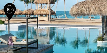 a pool with umbrellas and chairs by it