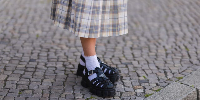 a person wearing a skirt and shoes