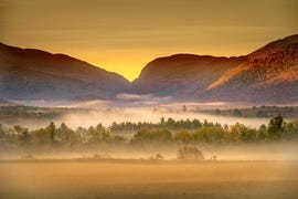 fog and morning mist just before sunrise over the adirondacks, upstate new york