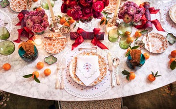 a holiday table full of color and flowers