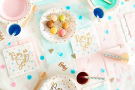 gender reveal party table with boy or girl napkins and macarons