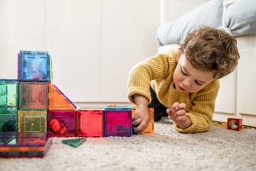 young boy playing with building blocks