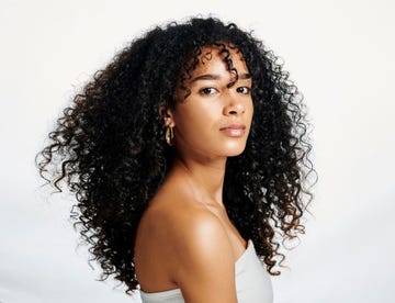 portrait of a young person posing against a white studio background