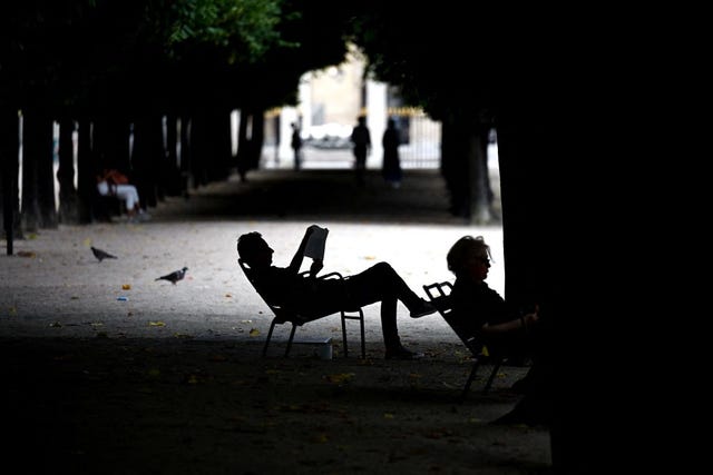 a man reads a book as he rests in jardin du palais royal in paris, on july 9, 2023 photo by sergei gapon afp photo by sergei gaponafp via getty images