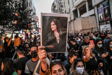 topshot   a protester holds a portrait of mahsa amini  during a demonstration in support of amini, a young iranian woman who died after being arrested in tehran by the islamic republics morality police, on istiklal avenue in istanbul on september 20, 2022   amini, 22, was on a visit with her family to the iranian capital when she was detained on september 13 by the police unit responsible for enforcing irans strict dress code for women, including the wearing of the headscarf in public she was declared dead on september 16 by state television after having spent three days in a coma photo by ozan kose  afp photo by ozan koseafp via getty images