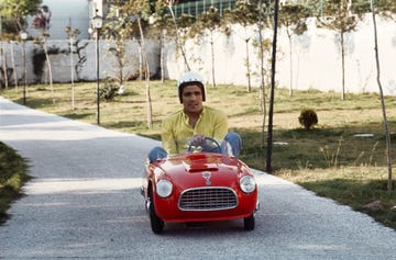 italian boxer nino benvenuti drives through the boulevard of the garden of his villa, onboard the red car of one of his sons, wearing a helmet the sportman is world champion of the welterweights italy, 1968 photo by marcello salustrimondadori via getty images