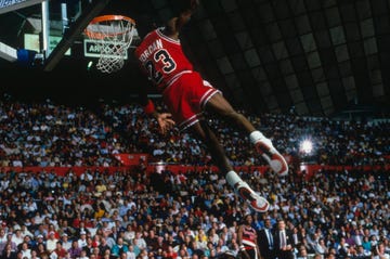 undated chicago bulls forward michael jordan 23 dunks as the crowd takes photos during a game against the portland trail blazers circa 1984 1998 photo by focus on sport via getty images