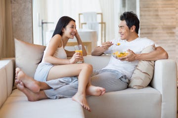 Happy young couple sitting on the sofa