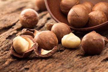 close up the macadamia nuts on wooden plate