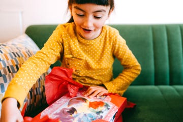 7 year old girl opening up gift