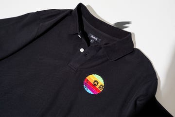 a black shirt with a colorful pin on it