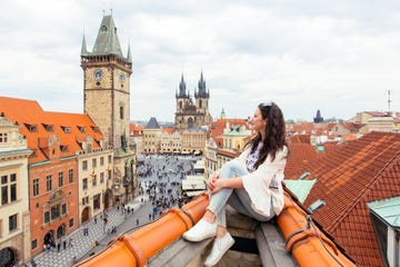 happy tourist looking at the old town square from above, prague, czech republic