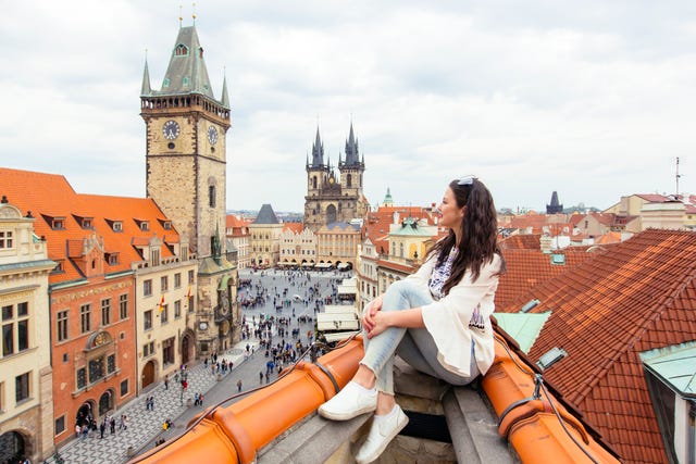 happy tourist looking at the old town square from above, prague, czech republic