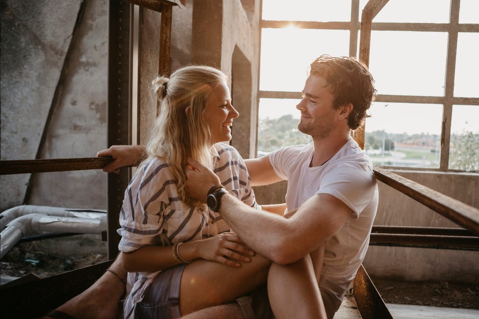 happy young couple cuddling in an old building