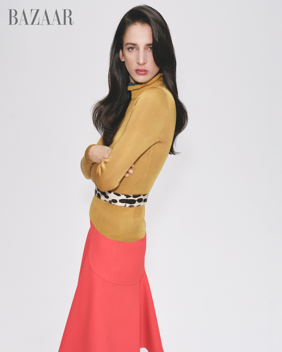 model wearing a stylish outfit with a yellow top and a pink skirt showcasing fashion