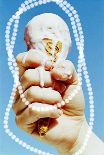 woman's hand gripping a melting ice cream cone