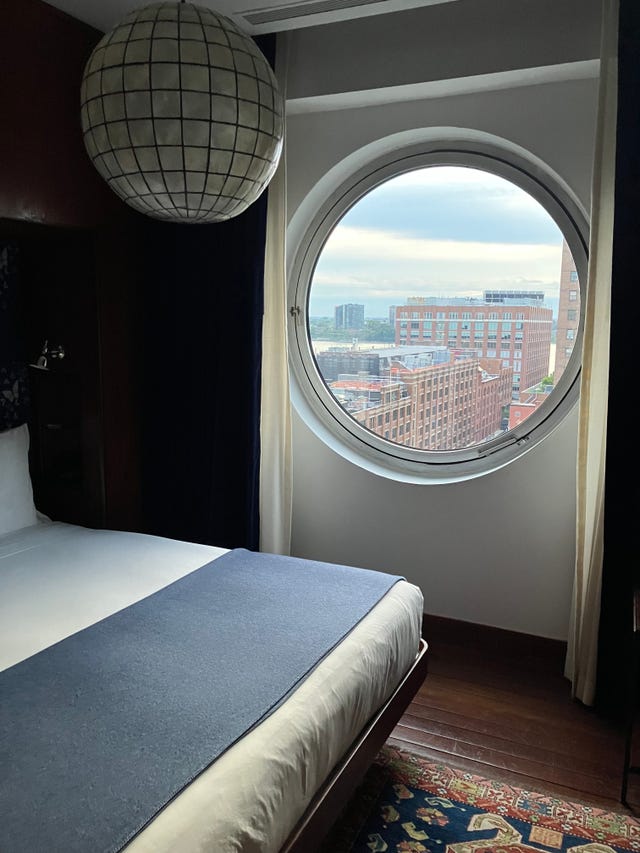 a hotel room bedroom with a large window