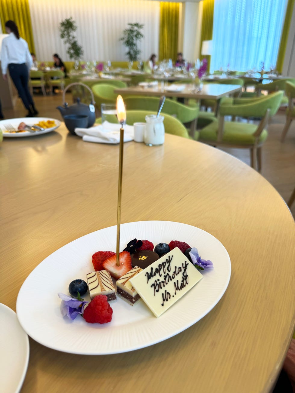 a plate of dessert with a candle