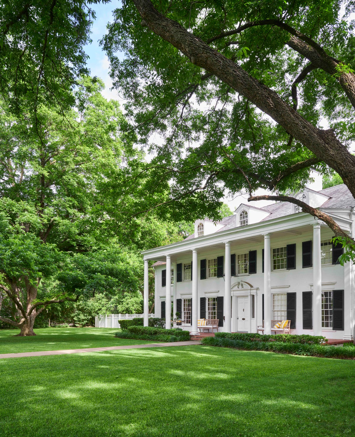 a three story white colonial home was designed by noted architect