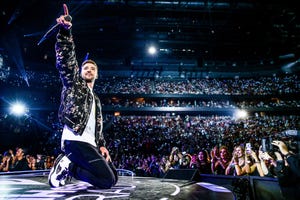 justin timberlake on stage with crowd behind him