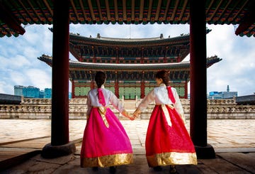 korean lady in hanbok or korea gress and walk in an ancient town and gyeongbokgung palace in seoul