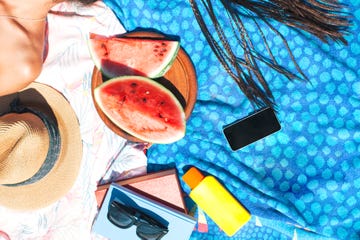 beach towels with watermelon, sunscreen, hat, phone