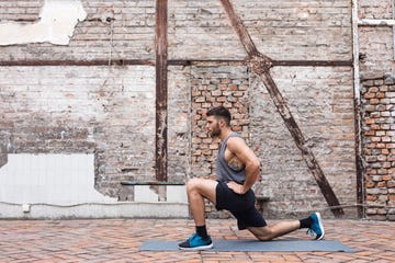 side view of a young fit man exercising on his fitness mat outdoors copy space