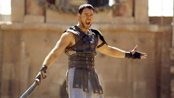 warrior in ancient gladiatorial attire with a sword in an arena setting