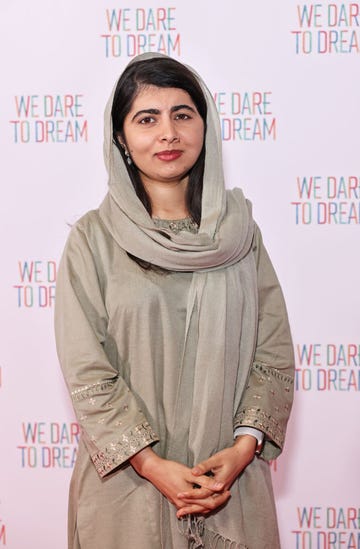 malala yousafzai posing for a photo at a film screening red carpet