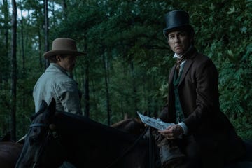 actor tobias menzies wearing a top hat and sitting on a horse portraying edwin stanton in a manhunt tv show scene