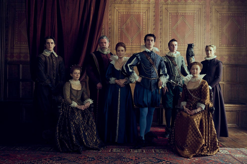 still from mary and george shows characters posing for group photo in period costumes