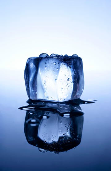 melting ice cube and reflection, close up