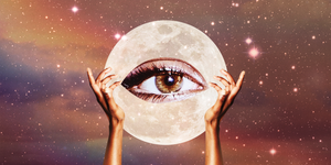 two hands hold up a giant eye over a full moon and a starry dark sky