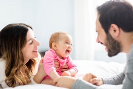 mother father and baby playing together