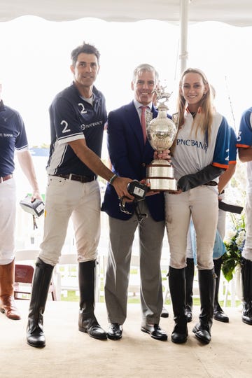 a group of people holding a trophy