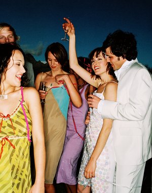 a group of people partying at a wedding reception