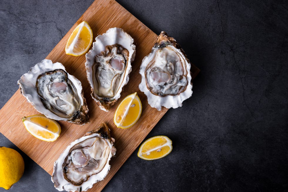 opened oysters on table with lemon