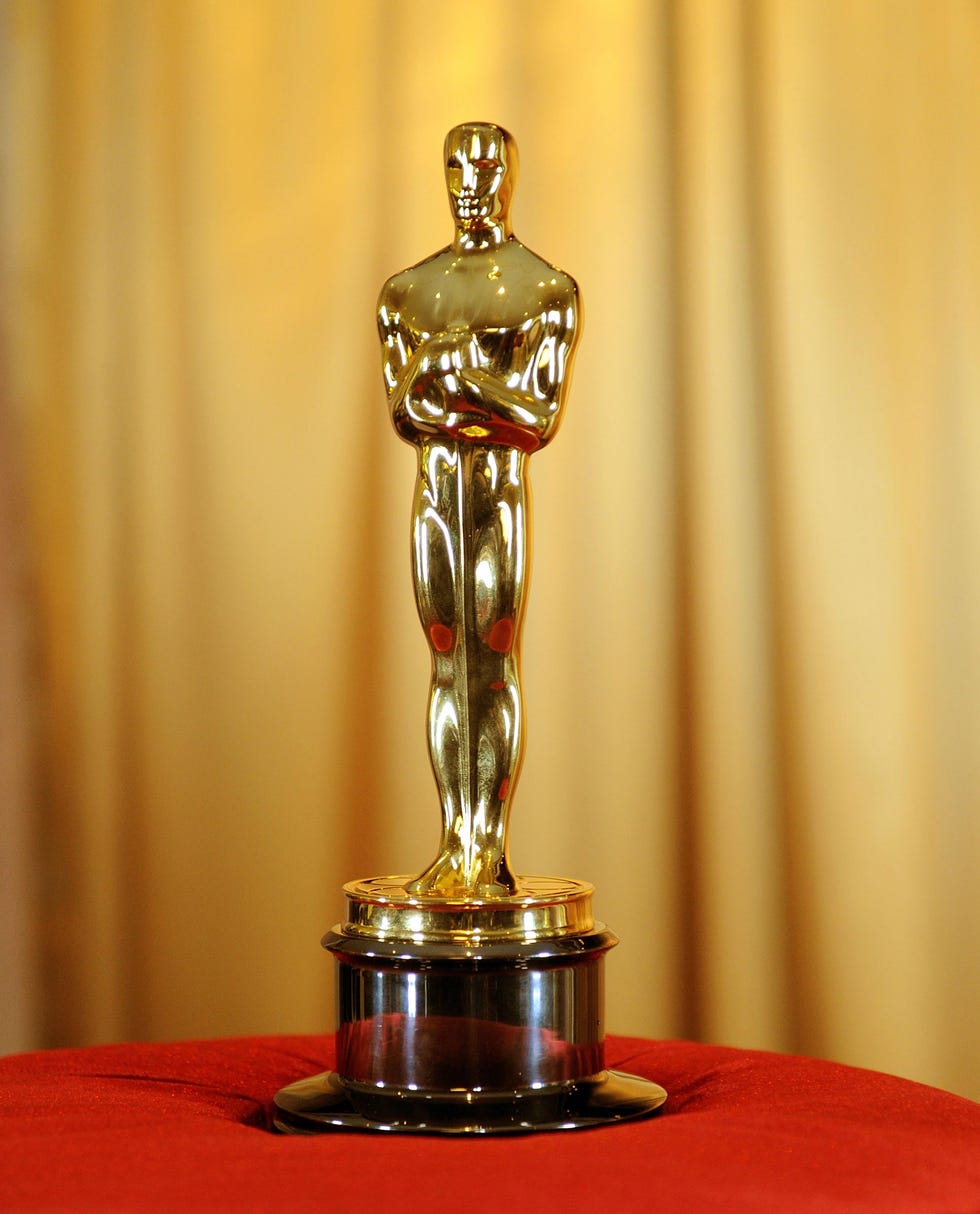 oscars statuette on red cushion