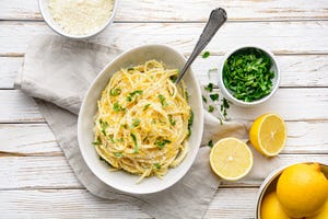 pasta al limone, delicious italian meal, spaghetti with parmesan, butter and lemon sauce, topped with fresh grated zest and cheese