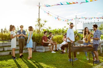 people enjoying asado party at backyard