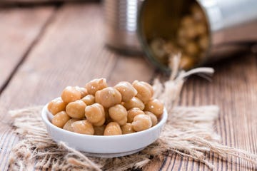 portion of chick peas canned on old wooden background,romania