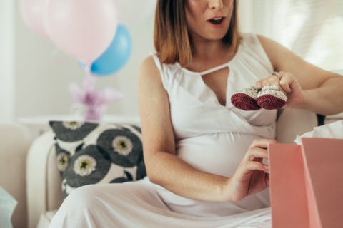 pregnant woman opening presents