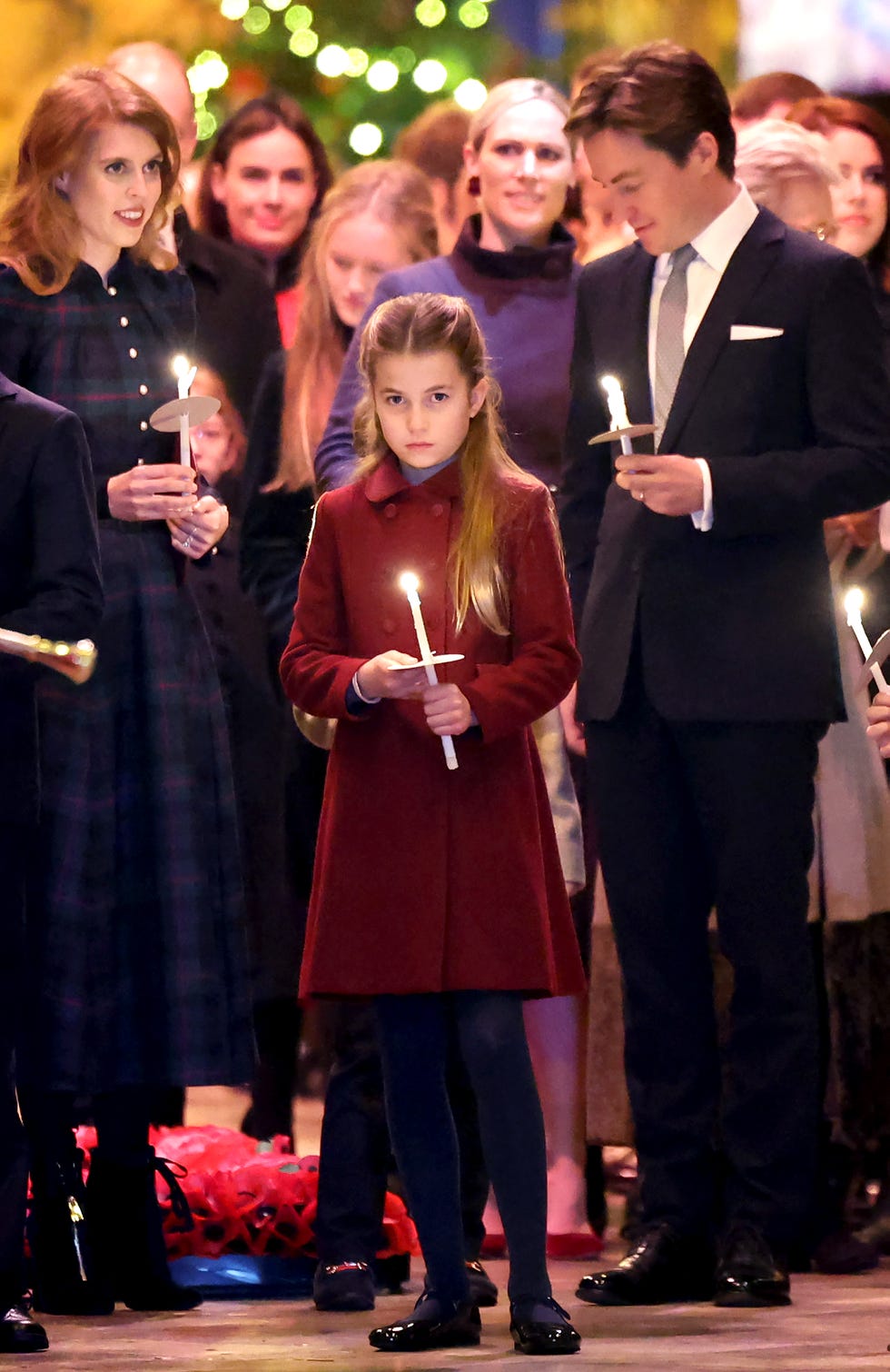 princess charlotte of wales holds a candle as she leaves with her family at the "together at christmas" carol service