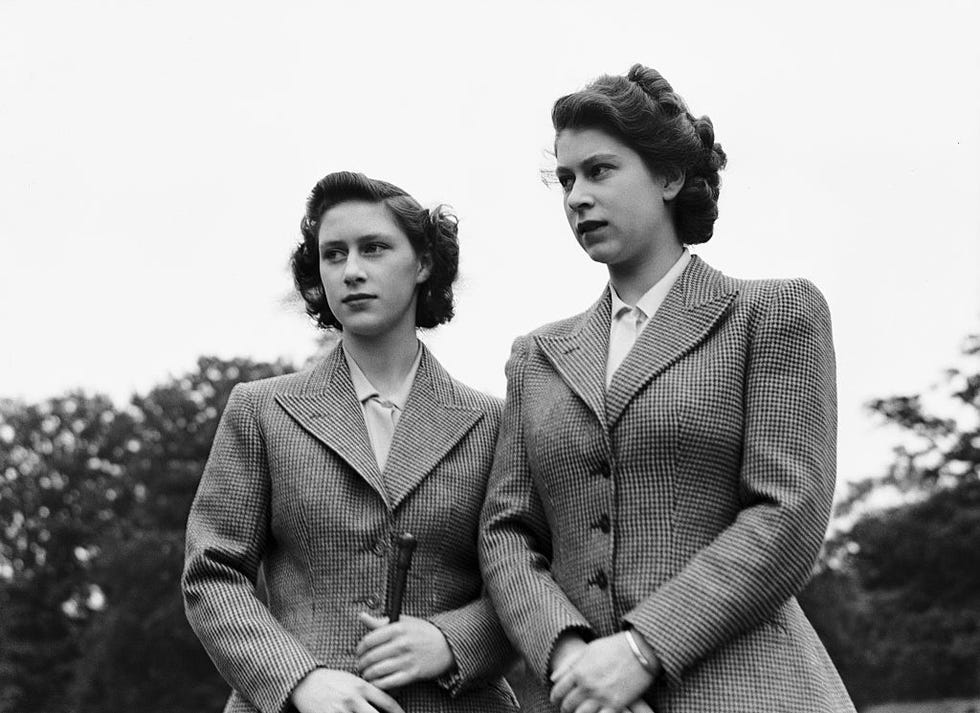 princesses elizabeth and margaret stand outside in matching plaid jackets and collared shirts