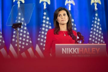 nikki haley standing at a podium with her name on it and looking out into the audience